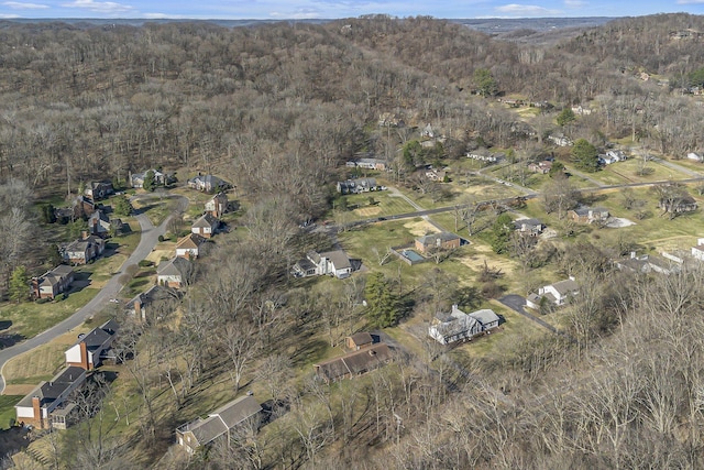 drone / aerial view featuring a wooded view