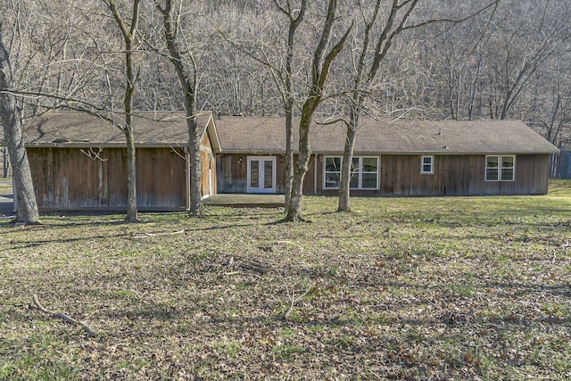 view of front of property featuring french doors and a front lawn