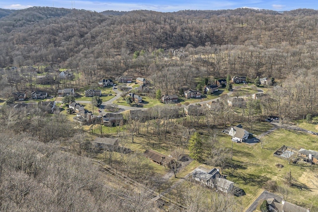 birds eye view of property with a view of trees