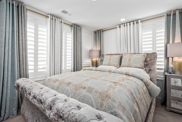 bedroom featuring visible vents and carpet flooring