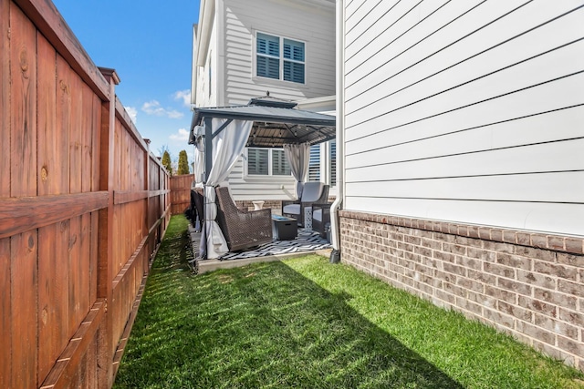 view of yard with a gazebo and a fenced backyard