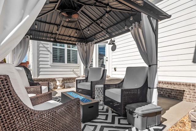 view of patio featuring an outdoor fire pit and a gazebo