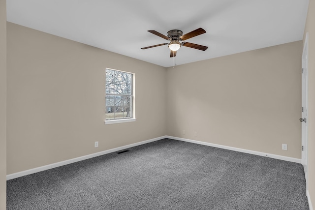 unfurnished room with carpet, visible vents, ceiling fan, and baseboards