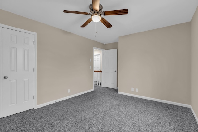 unfurnished room with carpet floors, ceiling fan, and baseboards