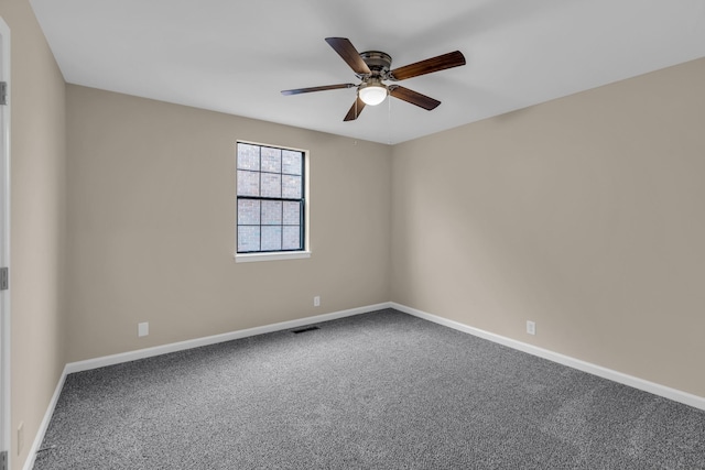 empty room with baseboards, visible vents, and carpet flooring