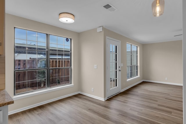 interior space featuring wood finished floors, visible vents, and baseboards