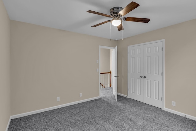 unfurnished bedroom featuring carpet floors, a closet, ceiling fan, and baseboards