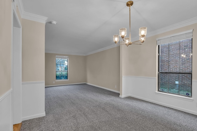 unfurnished room featuring a chandelier, ornamental molding, carpet, and baseboards