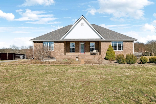 single story home with brick siding, a front lawn, and roof with shingles