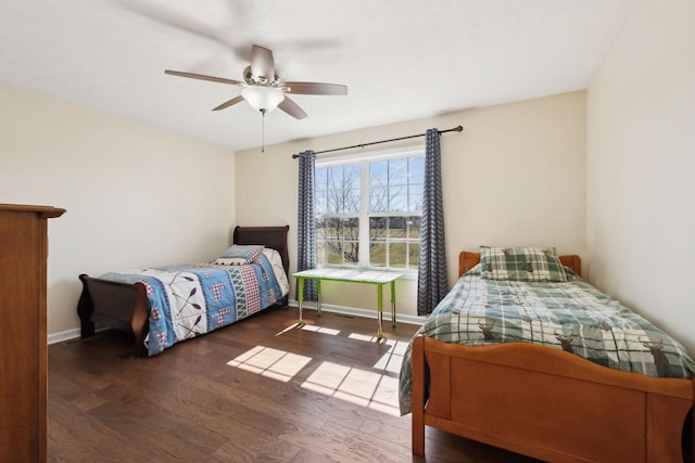 bedroom with ceiling fan, baseboards, and wood finished floors