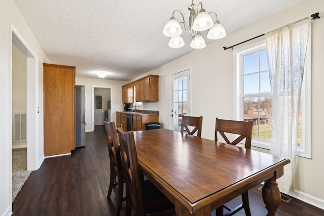 dining area with baseboards, visible vents, dark wood finished floors, and a textured ceiling