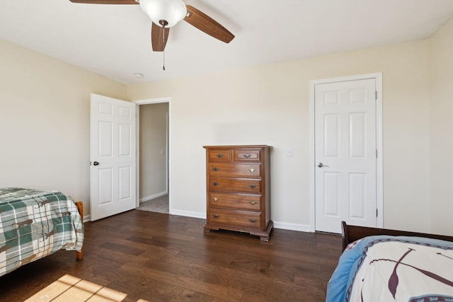 bedroom featuring dark wood-style flooring, ceiling fan, and baseboards