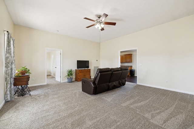 living area featuring carpet floors, visible vents, ceiling fan, and baseboards