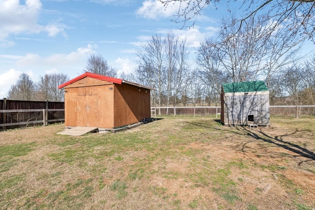 view of yard with an outbuilding, a fenced backyard, and a storage shed