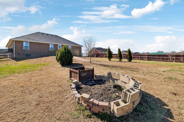 view of yard with fence and a garden