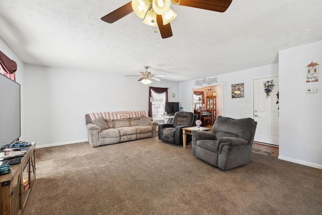 living area with carpet flooring, a textured ceiling, and baseboards