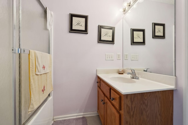 bathroom with a bathing tub, an enclosed shower, vanity, and baseboards