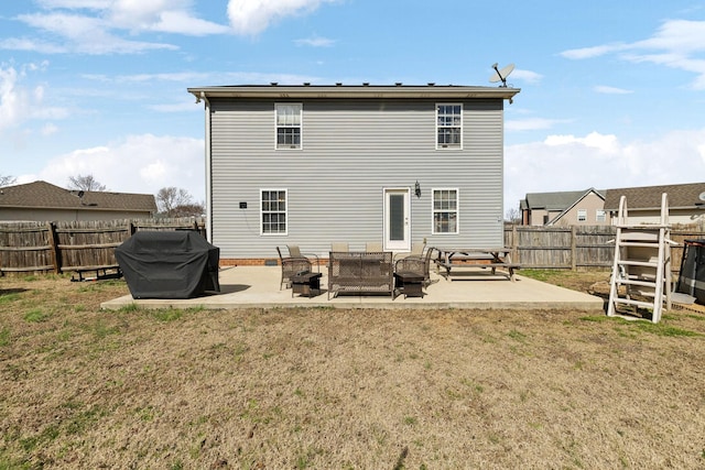 rear view of house featuring a yard, a patio area, and a fenced backyard