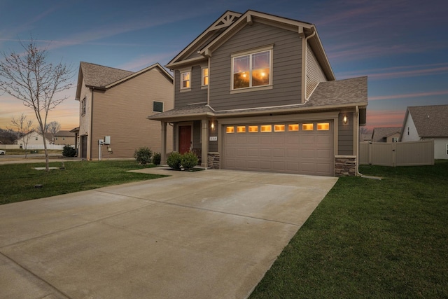 view of front of house with an attached garage, stone siding, a front lawn, and concrete driveway