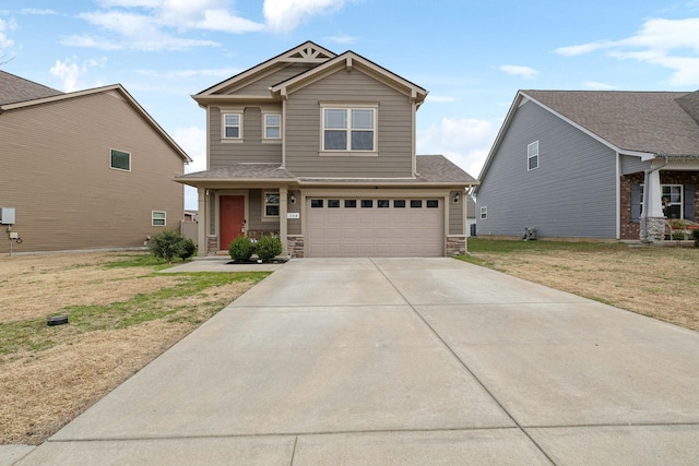 craftsman house featuring a garage, stone siding, driveway, and a front lawn