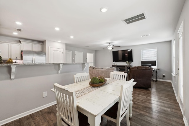 dining room featuring dark wood-style floors, baseboards, visible vents, and recessed lighting