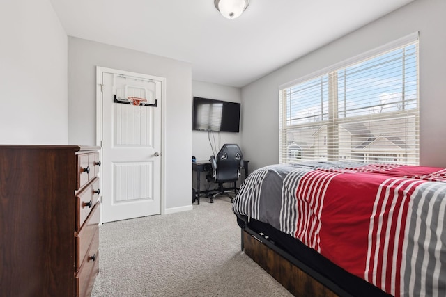 carpeted bedroom featuring baseboards