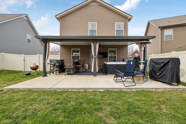 rear view of house featuring a patio area, a yard, and a fenced backyard