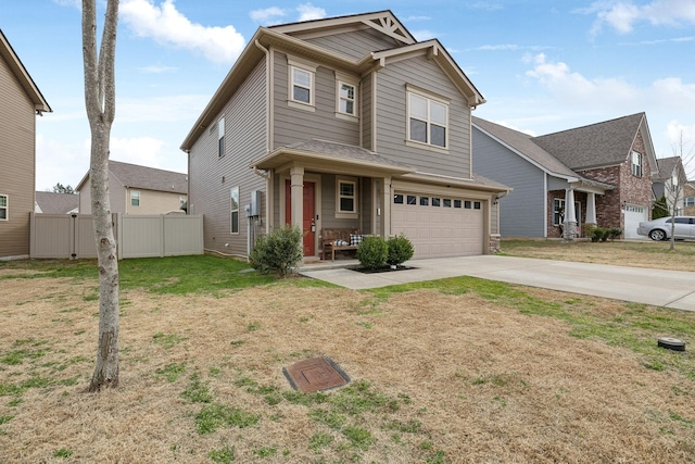 traditional home featuring a garage, fence, concrete driveway, and a front yard