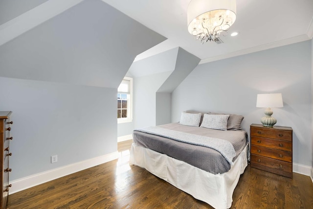 bedroom with lofted ceiling, an inviting chandelier, baseboards, and wood finished floors