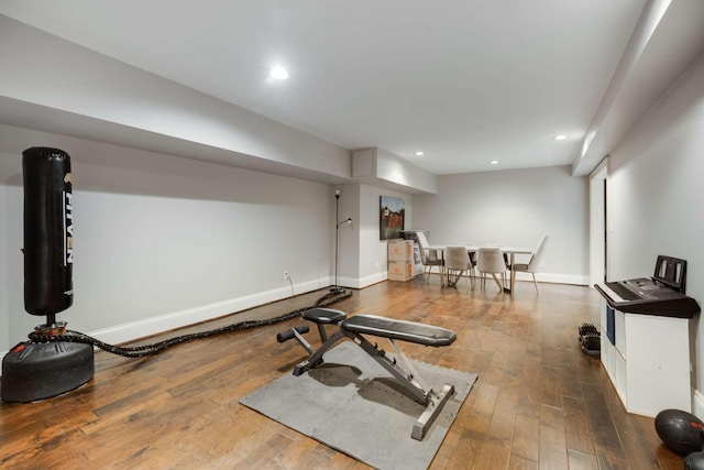 workout area featuring recessed lighting, wood-type flooring, and baseboards