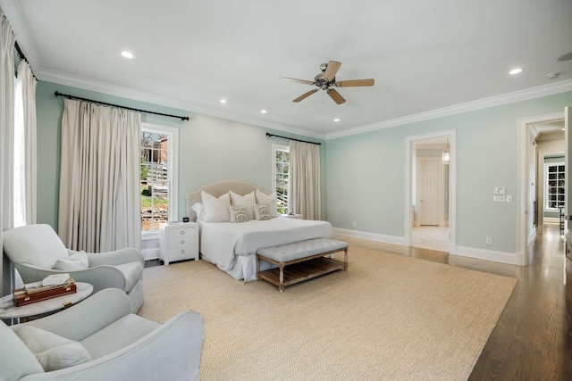 bedroom featuring baseboards, ornamental molding, wood finished floors, and recessed lighting