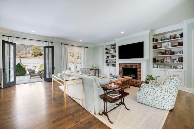 living room with crown molding, wood finished floors, and french doors