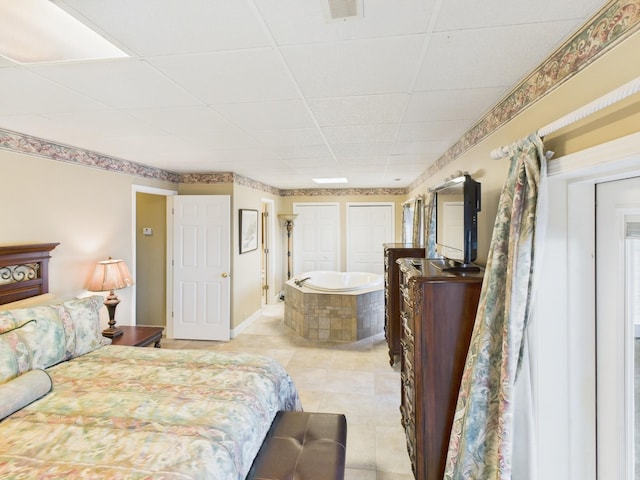 bedroom featuring visible vents, a drop ceiling, and light tile patterned flooring