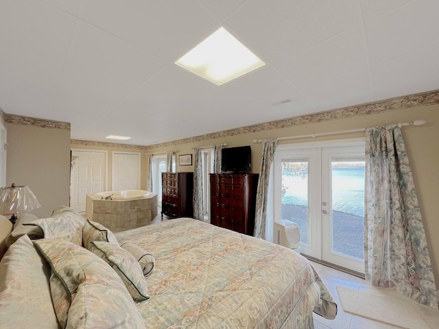 bedroom with french doors, a wall mounted AC, and access to exterior