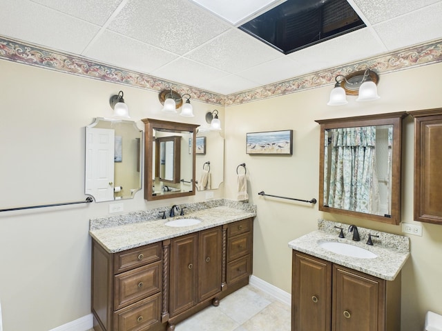 full bath featuring two vanities, a sink, and visible vents