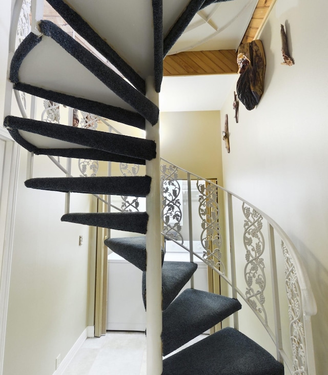 staircase featuring baseboards