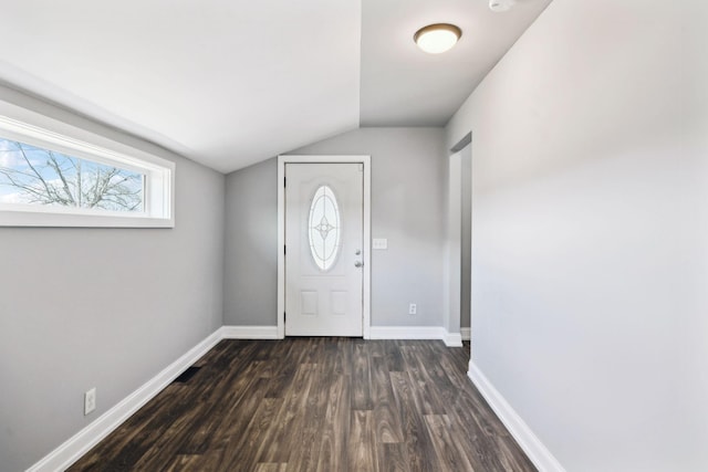 entryway with dark wood-style flooring, vaulted ceiling, and baseboards