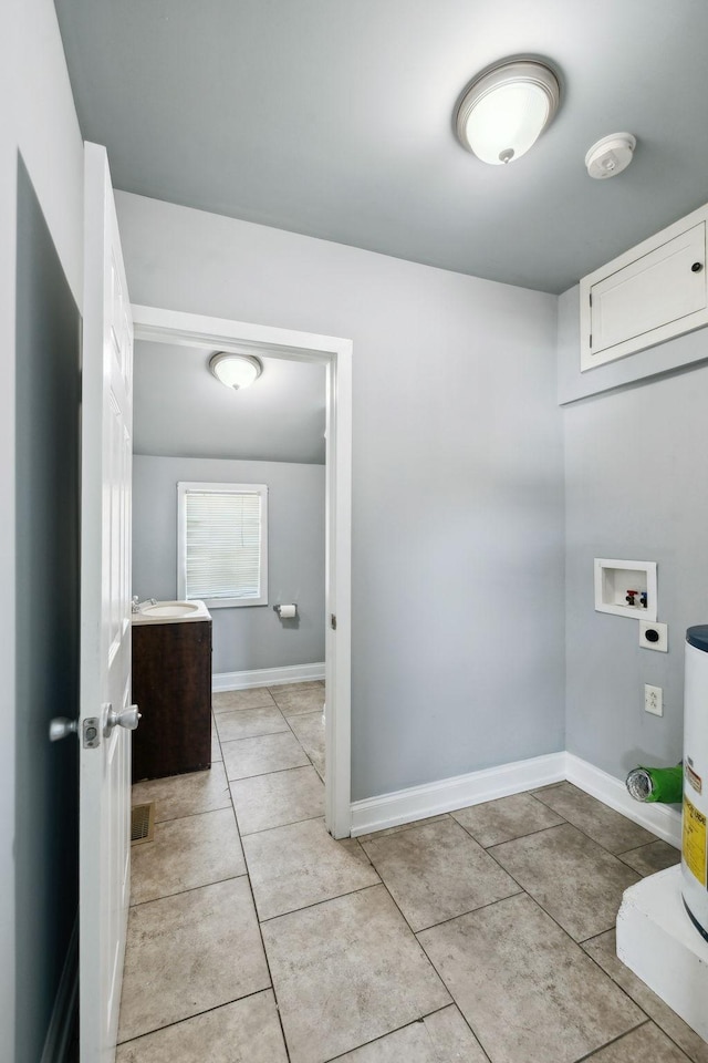 laundry room with washer hookup, light tile patterned floors, visible vents, laundry area, and baseboards