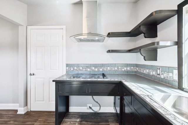 kitchen featuring black electric cooktop, dark wood-style flooring, decorative backsplash, open shelves, and island exhaust hood