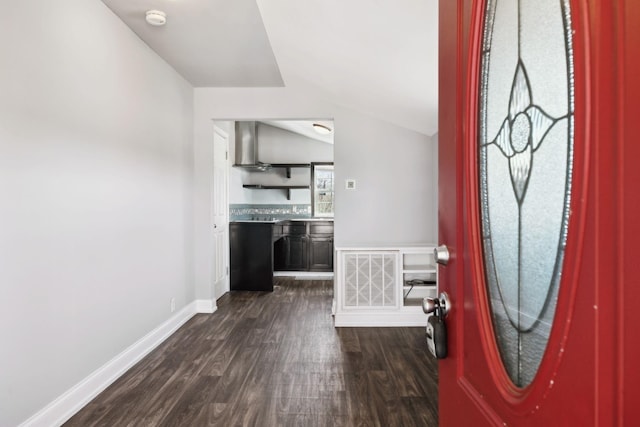 entryway with lofted ceiling, dark wood-style floors, baseboards, and visible vents