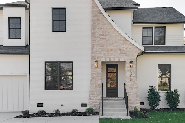 view of front of house with brick siding, a shingled roof, crawl space, a garage, and stone siding