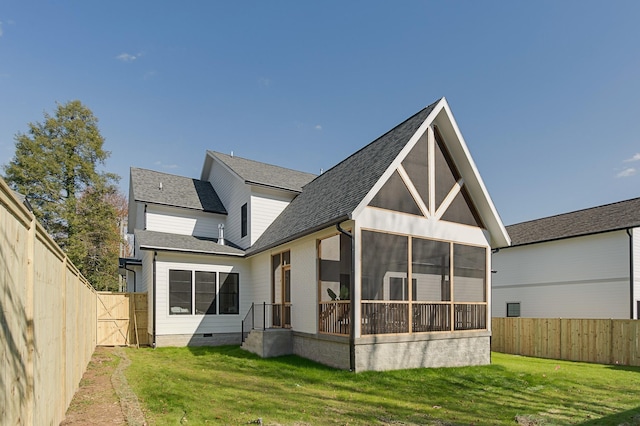 back of house featuring a lawn, crawl space, a fenced backyard, and a sunroom