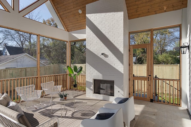 sunroom / solarium with a wealth of natural light, wood ceiling, and lofted ceiling