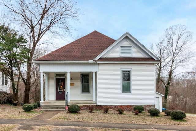 view of front of property with covered porch and a shingled roof