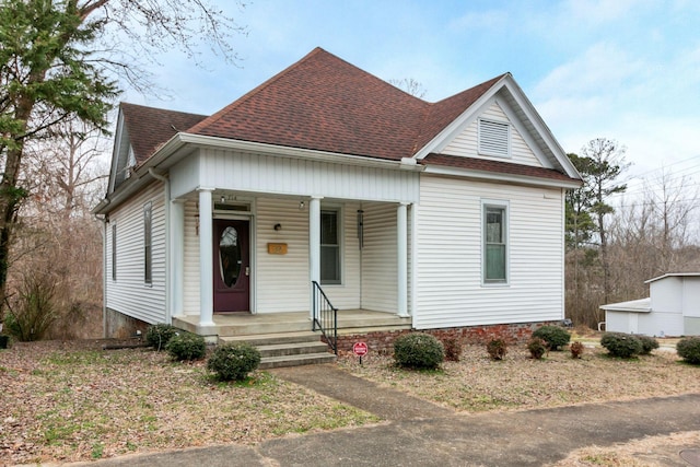 view of front facade with a porch and roof with shingles