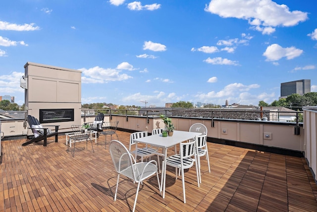 deck featuring a city view and outdoor dining space