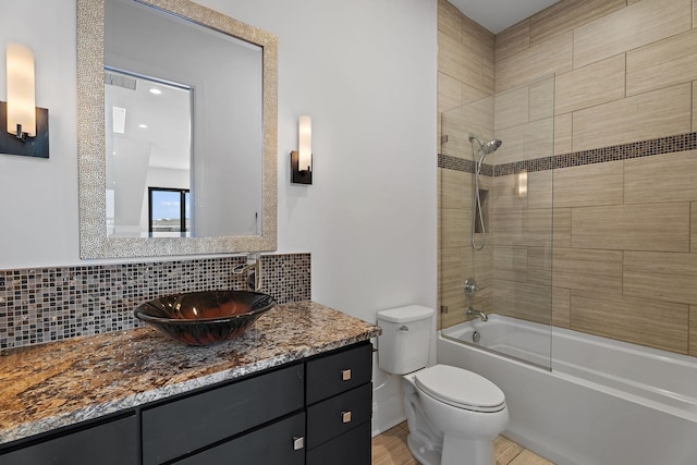 full bath featuring vanity, shower / washtub combination, backsplash, and toilet