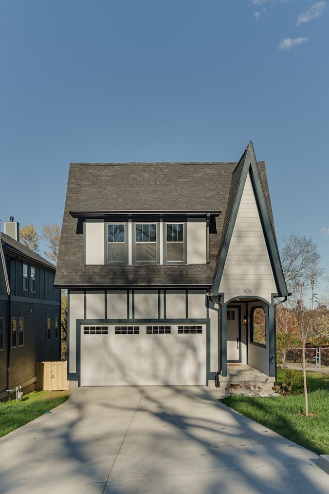 view of front of home with driveway and a garage