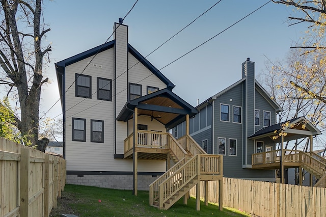 back of house with fence, stairway, a ceiling fan, and a wooden deck