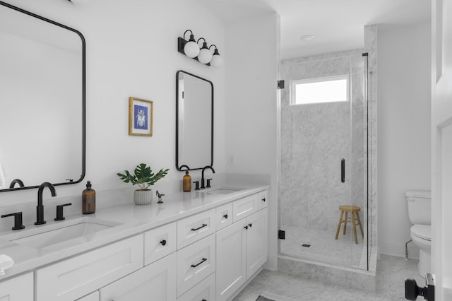 full bath featuring toilet, a marble finish shower, and a sink